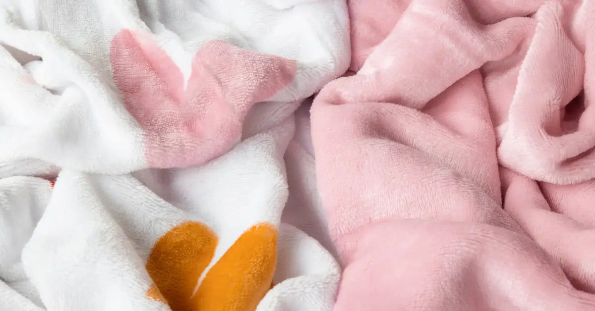 Close-up van een zachte velvetstof in een dekbedovertrek, met een patroon van schattige hartjes. De stof heeft een luxueuze, glanzende textuur en is ontworpen voor kinderen, met een speels en knus uiterlijk. foto: hartjes dekbedovertrek stof.